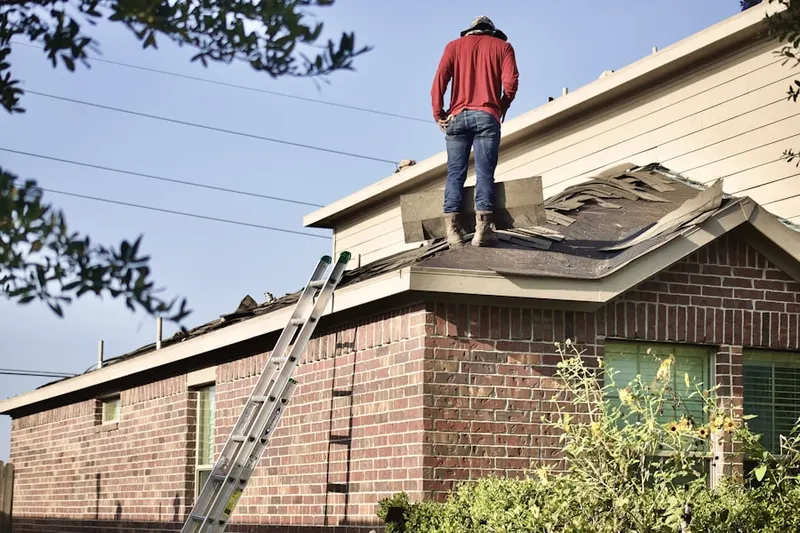 Professional roofer working on a residential roof in Brookthorpe Hills